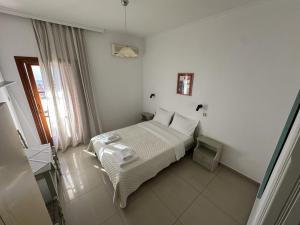a bedroom with a bed in a white room at Filoxenia Studios 1 in Palaiochora