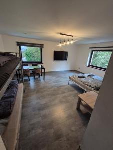 a room with two beds and a flat screen tv at Chillout Place in Wieprz