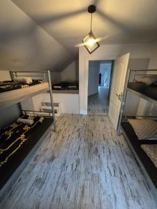 a room with two bunk beds and a hallway at Chillout Place in Wieprz +1 photo
