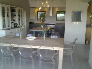 a kitchen with a dining table and chairs at Dinvorae in Southbroom