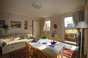 a living room with a table and a couch at Casa Novecento "Rooms & apartments" in Feltre