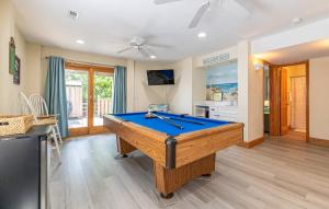 a pool table in a living room with at On Island Time - KDH MP 7, 275 Yds to Beach, Pool, Hot Tub, Pool Table, Flex Stays in Kill Devil Hills
