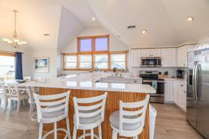 a kitchen with a large island with white counter tops at On Island Time - KDH MP 7, 275 Yds to Beach, Pool, Hot Tub, Pool Table, Flex Stays in Kill Devil Hills