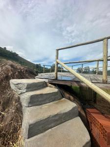 a set of concrete stairs with a metal railing at Chalé Face de Cristo in Caparaó Velho