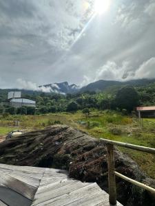 a view of a dirt field with mountains in the background at Chalé Face de Cristo in Caparaó Velho