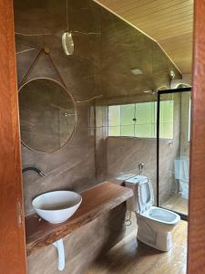a bathroom with a sink and a toilet at Chalé Face de Cristo in Caparaó Velho