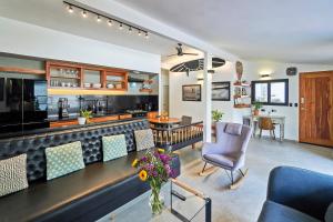 a kitchen and living room with a counter and chairs at Villa Taleona in Santa Teresa Beach