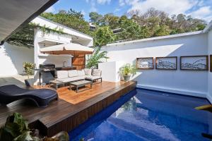 a house with a swimming pool and a patio at Villa Taleona in Santa Teresa Beach