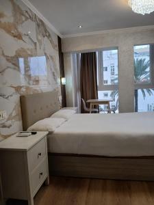 a bedroom with a large bed with a stone wall at Costa Marbella Star Light in Marbella