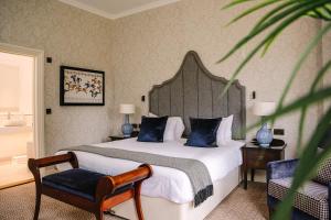 a bedroom with a large bed and a chair at Royal Berkshire in Ascot +122 photos