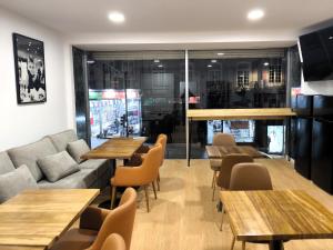a restaurant with tables and a couch and chairs at Clérigos Cinema Guesthouse in Porto +88 photos