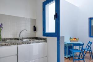 a kitchen with a sink and a table at Casa Eva in Famara