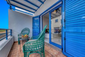 a patio with two chairs and a table on a balcony at Casa Eva in Famara