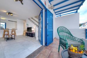 a room with a blue door and a basket of fruit at Casa Eva in Famara