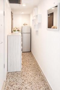 a hallway with a refrigerator in a room at Sorrento life 3 in Sant'Agnello