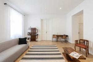 a living room with a couch and a table at Apartments Paprikör in Tihany