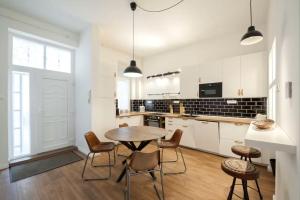 a kitchen with a table and chairs in a room at Apartments Paprikör in Tihany