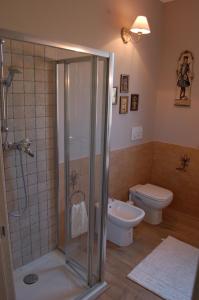 a bathroom with a shower and a toilet at Borgo Sacramento in Marta +20 photos