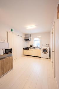 a white kitchen with a washer and dryer in it at BIEI BREEZE RESERVE Sui 水 in Biei