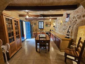 a kitchen with a table and chairs in a room at Dotties Retreat Qala in Qala