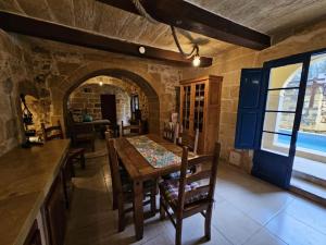 a kitchen and dining room with a table and chairs at Dotties Retreat Qala in Qala