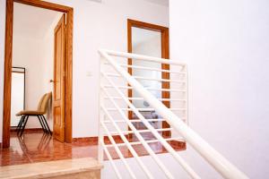 a white staircase in a room with a chair at Manomar II, tu refugio en Gata in Gata