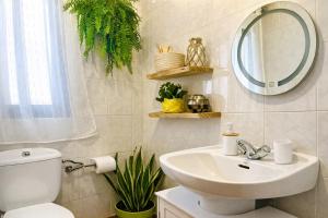 a bathroom with a toilet and a sink and a mirror at Manomar II, tu refugio en Gata in Gata