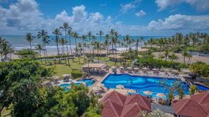 an aerial view of a resort with a swimming pool and the beach at Jardim Atlântico Beach Resort in Ilhéus