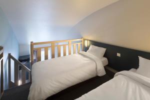 Postel nebo postele na pokoji v ubytování B&B HOTEL Auxerre Bourgogne