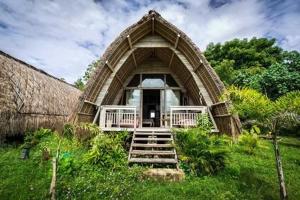 a building with a staircase leading to the front of it at Gipsy Beach Bungalows in Sekotong