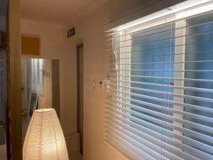 a window with blinds in a room with a lamp at Konkuk College of Art residence 2 in Seoul +10 photos