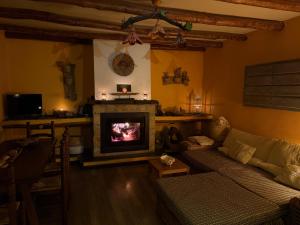 a living room with a couch and a fireplace at CASA RURAL CORTIJO MOLINO ALTERO in Trevélez