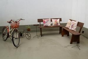 a bike parked next to two benches with pillows at Casinha Vale do Sol in Nova Lima