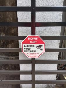 a security alert sign on a metal fence at Estudio 007, Palolem in Canacona
