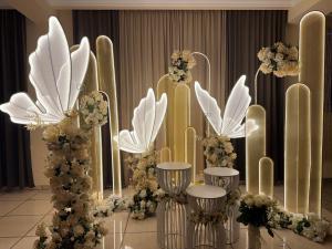 a room with white and gold flowers and columns at Liga Hotel and Restaurant in Shinuhayr