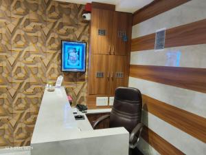 an office with a desk and a chair in a room at Hotel Sunlight in Ahmedabad