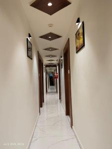 an empty hallway in a office building with a long corridor at Hotel Sunlight in Ahmedabad