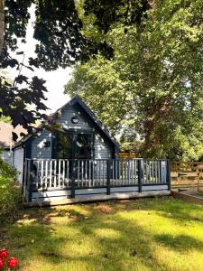 a small shed with a fence in a yard at Morrigan 7-Hot Tub-Pet Friendly-Boutique-Perthshire-Families in Perth