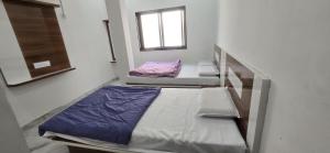 two bunk beds in a room with a window at Hotel Shri Hari Har Inn in Godarpura