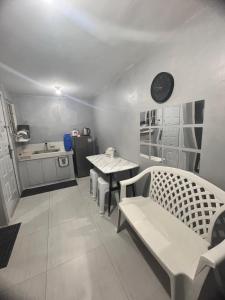 a living room with a table and a kitchen at Alilonch Transient in Mangangbukol