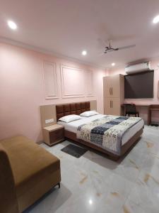 a bedroom with a bed and a flat screen tv at Hotel Kanak Shree in Godarpura +12 photos