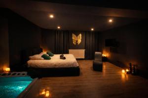 a bedroom with a bed and a swimming pool at Le Secret' - Balnéo - Romantique Room in Pélussin