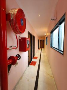 a hallway with a red fire hydrant on a wall at Hotel Kanak Shree in Godarpura