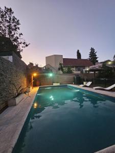 a swimming pool in a house at night at Complejo de departamentos 7 Cielos in Villa Carlos Paz