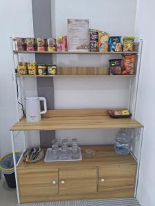 a shelf in a kitchen with food items on it at Comfort Home stay Private Room A Shared House in Ban Tha Khun +11 photos