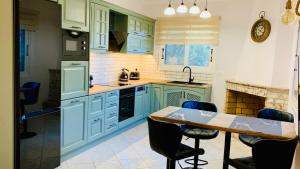 a kitchen with blue cabinets and a table with chairs at Apartment Voula Myrtos in Anomeriá