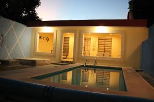 a house with a swimming pool in front of it at Casa 3 Torres, Calle 76 in Mérida