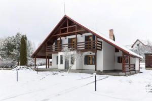a house with a gambrel roof in the snow at Heritage Villa Predelut - Fireplace & Baby Crib in Predeluţ