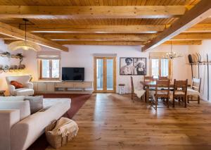 a living room with a couch and a table at Heritage Villa Predelut - Fireplace & Baby Crib in Predeluţ