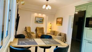 a living room with a table and chairs at Apartment Voula Myrtos in Anomeriá +17 photos